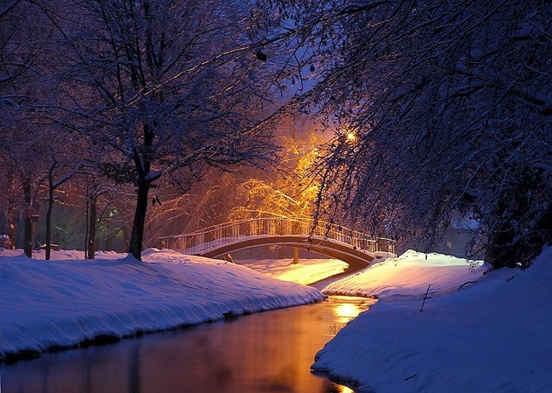 Snowy bridge at night