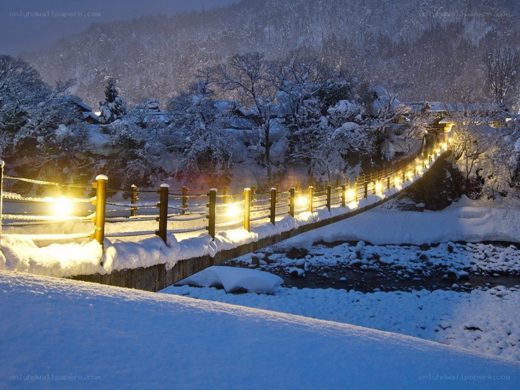 Snowy bridge at night