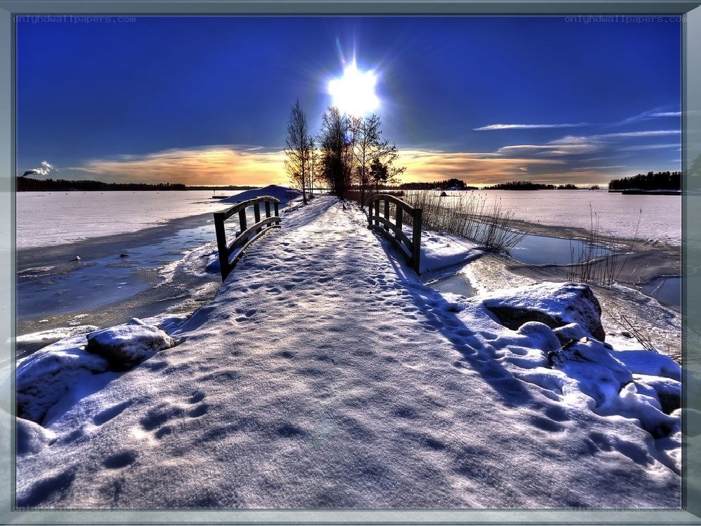 Snowy bridge at sunset