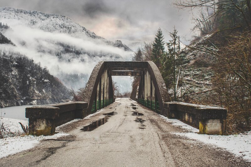 Snowy bridge in mountain valley