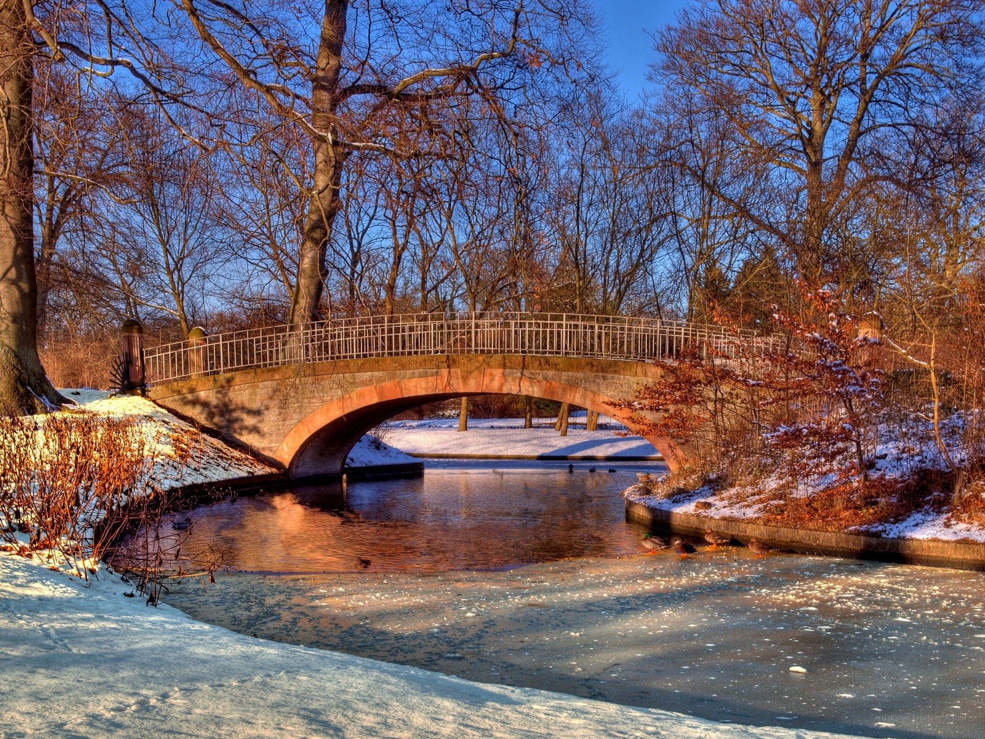 Snowy bridge over a river