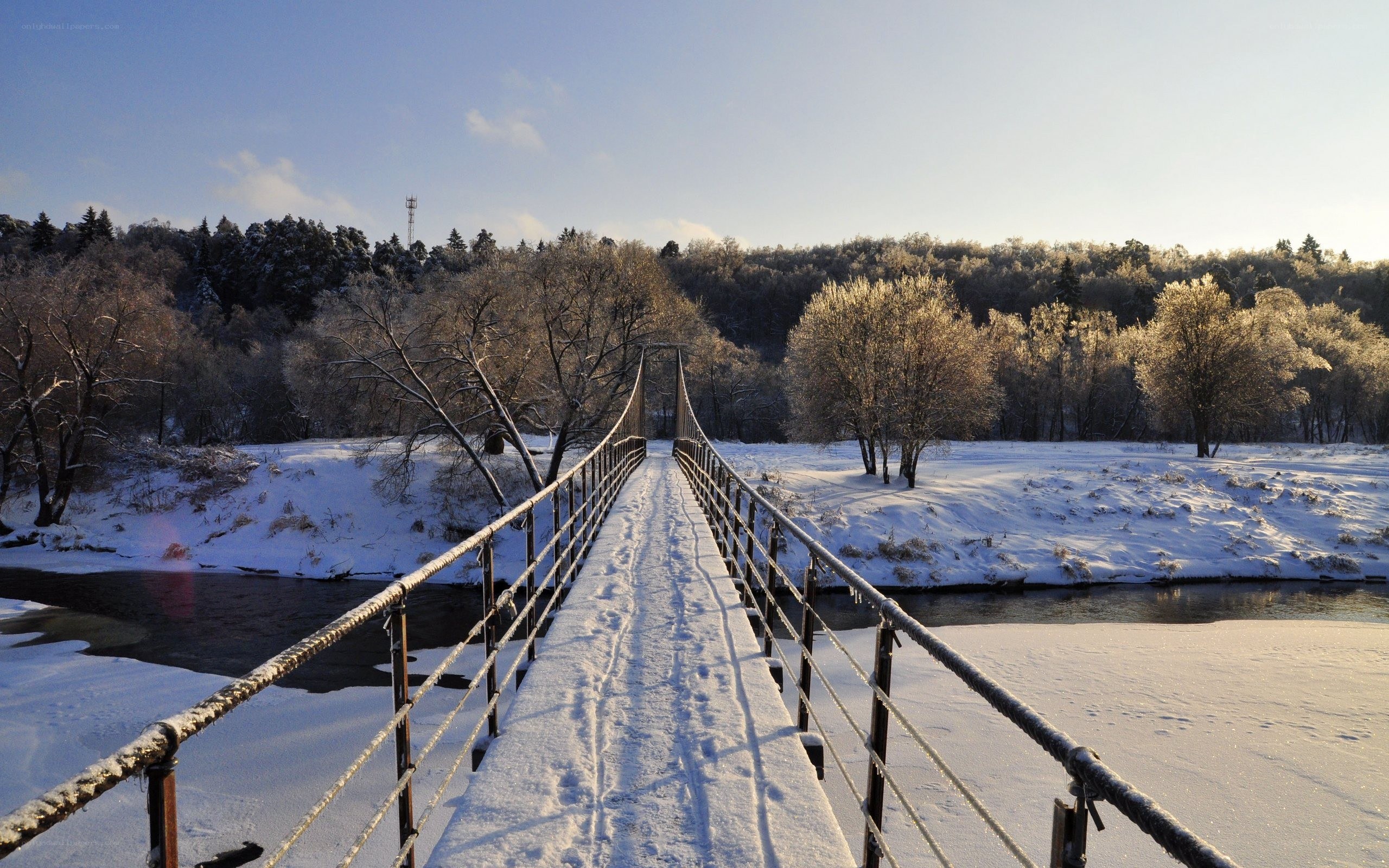 Snowy bridge over a river