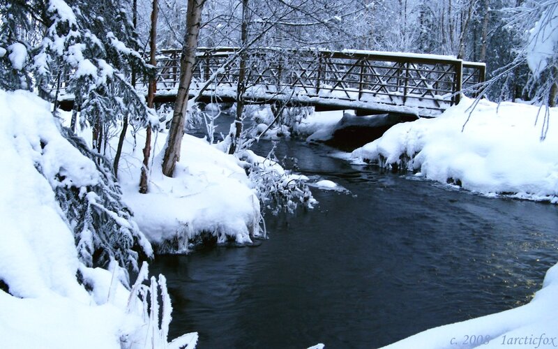 Snowy bridge over a stream