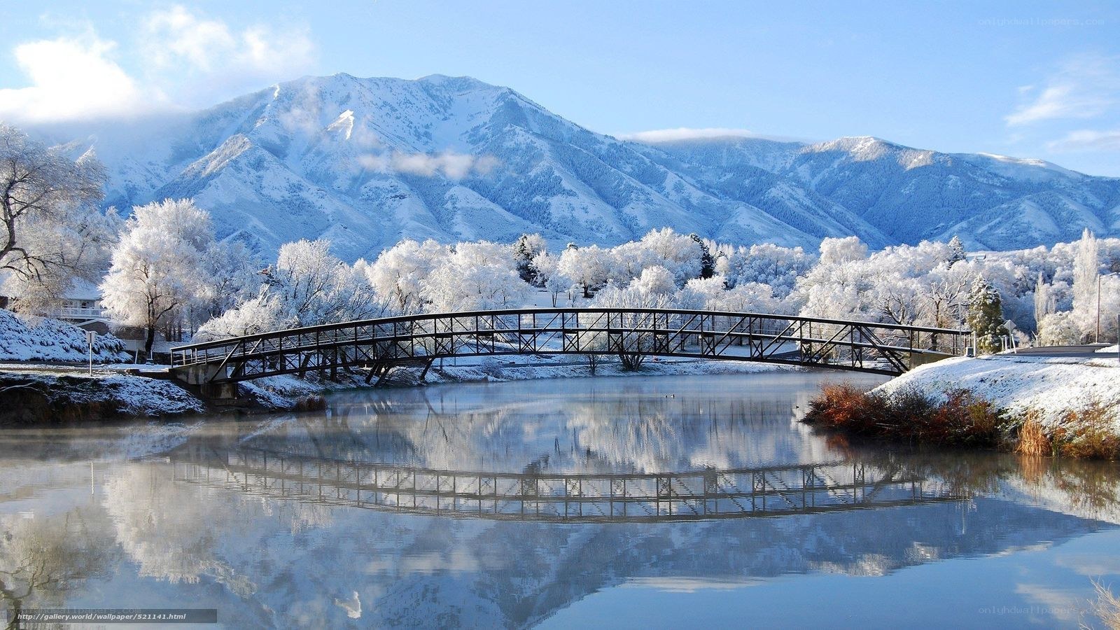 Snowy bridge over calm river
