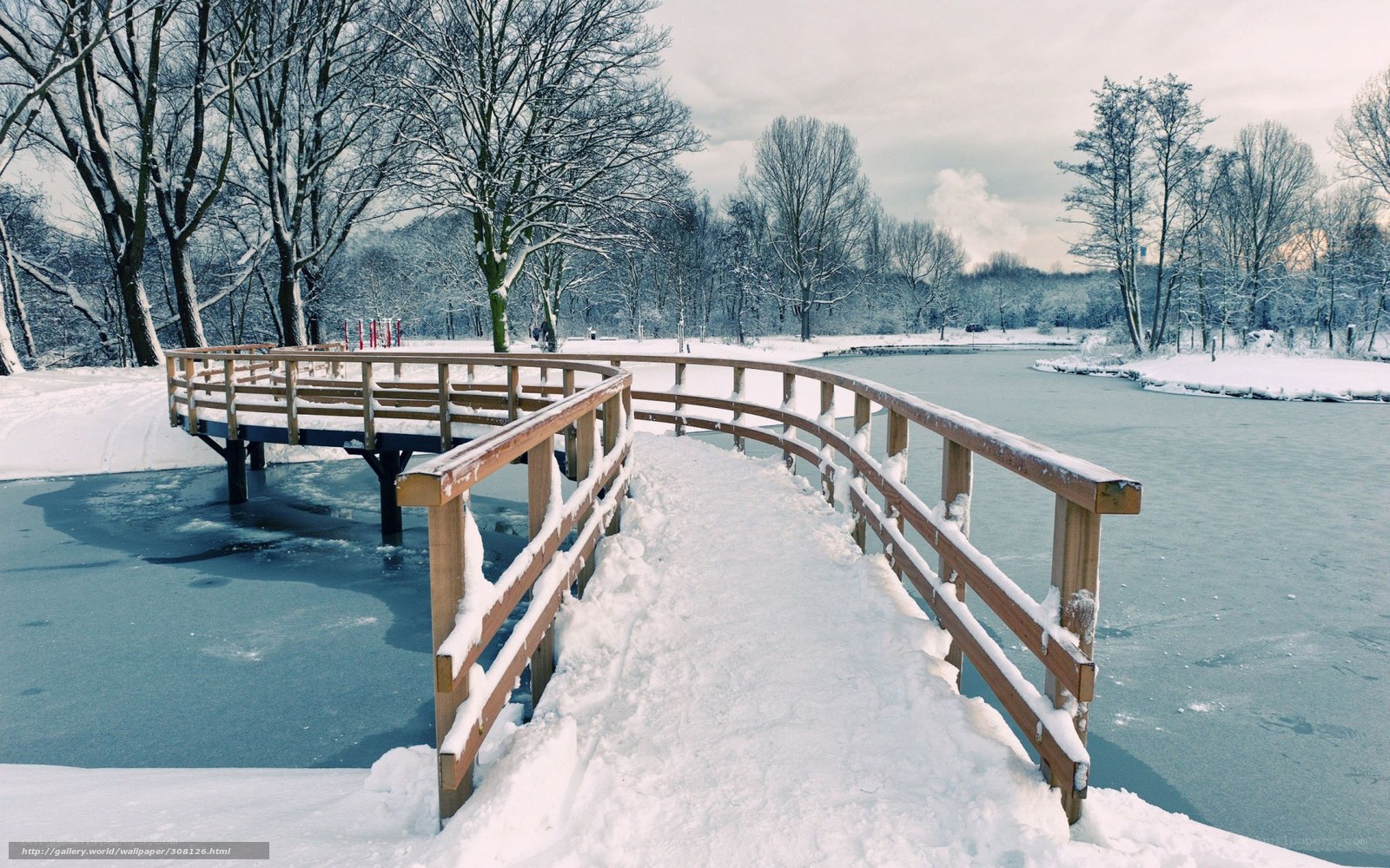 Snowy bridge over frozen lake