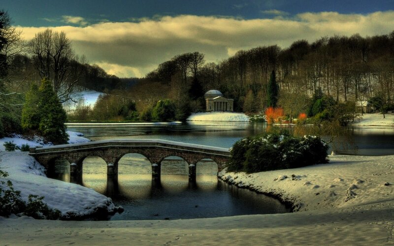 Snowy bridge over lake