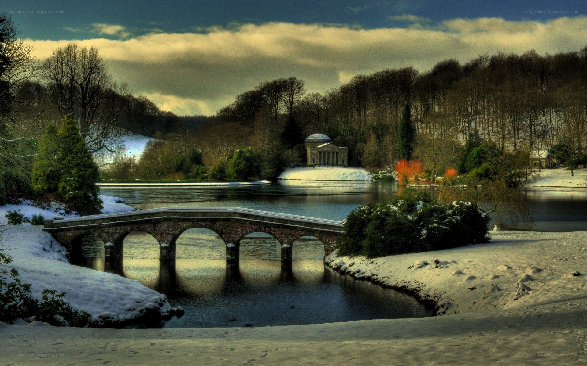 Snowy bridge over lake