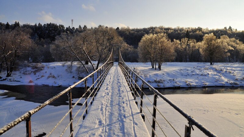 Snowy bridge over river