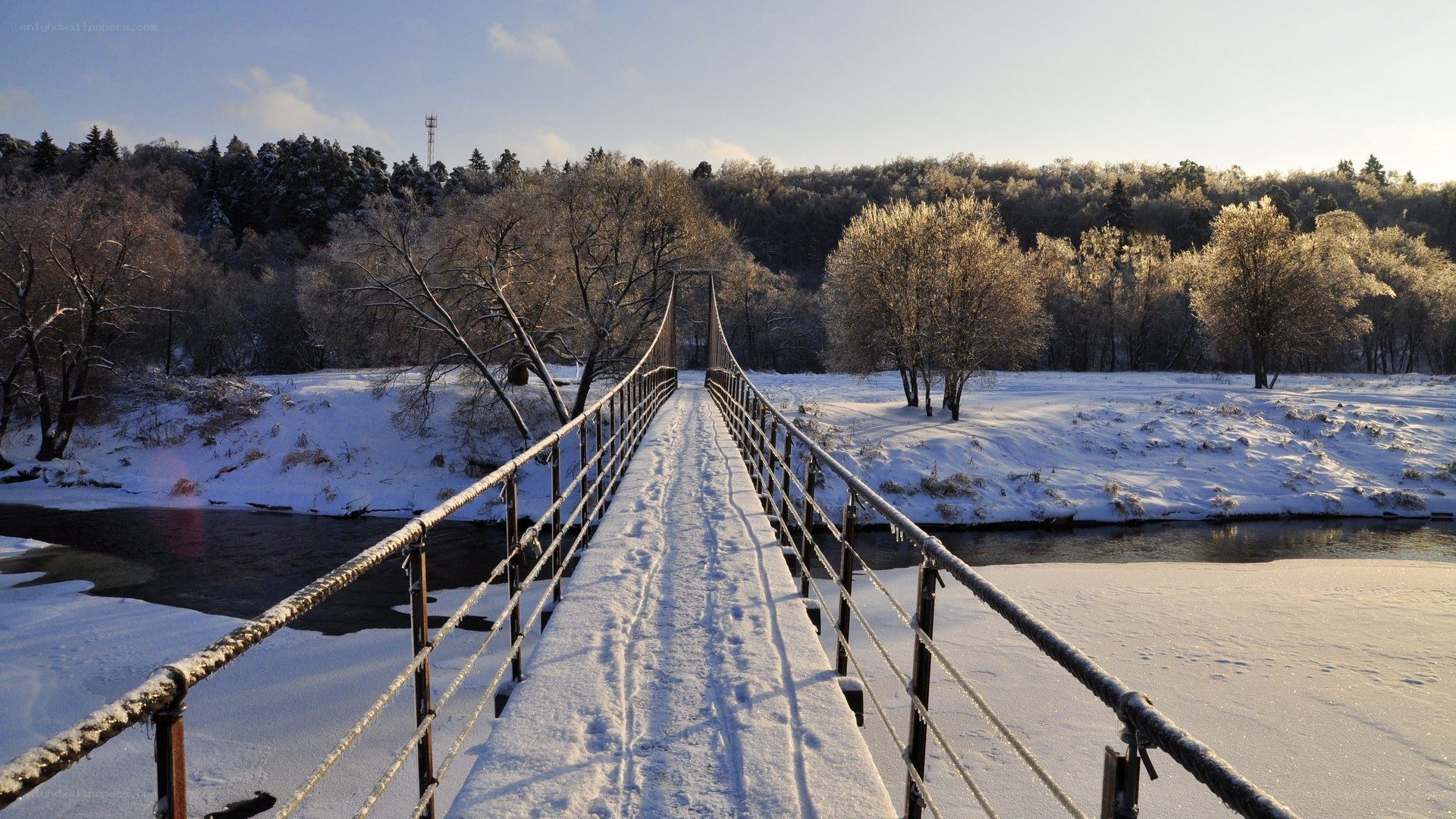 Snowy bridge over river