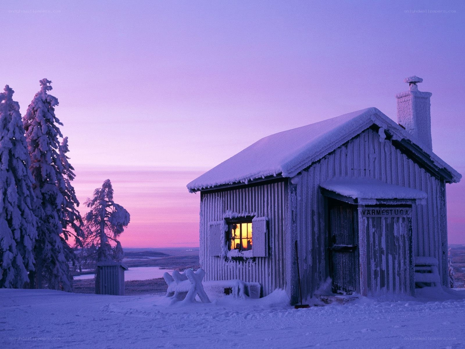 Snowy cabin at dusk