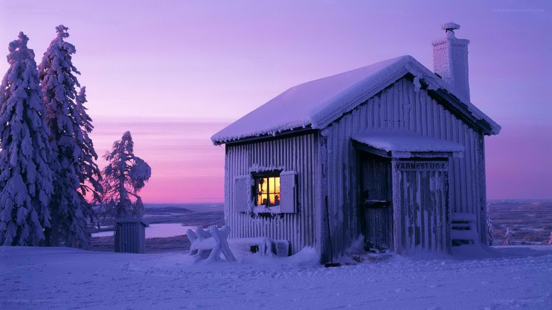 Snowy cabin at dusk