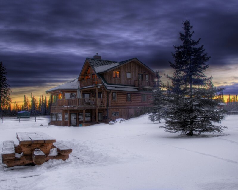 Snowy cabin at dusk