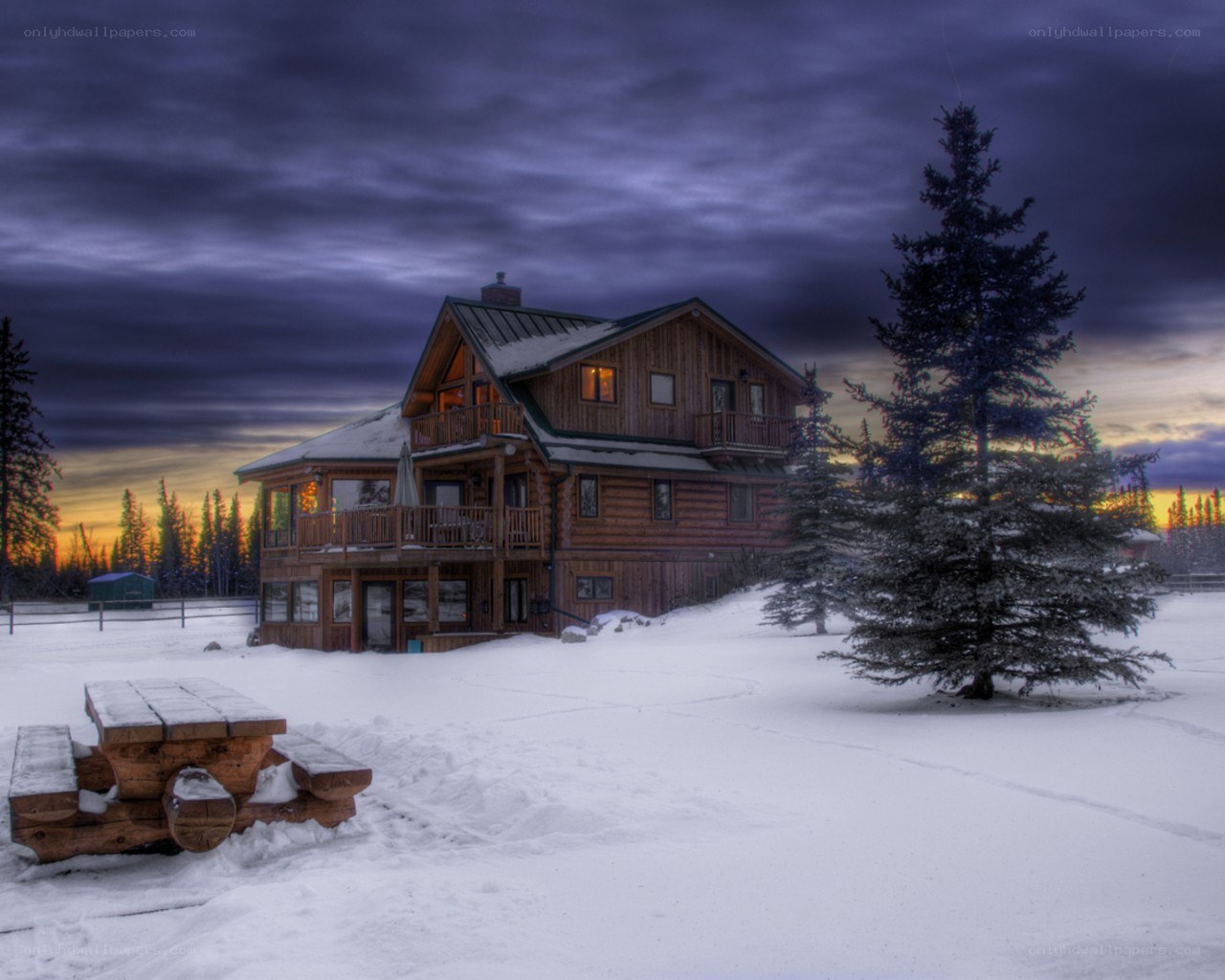 Snowy cabin at dusk