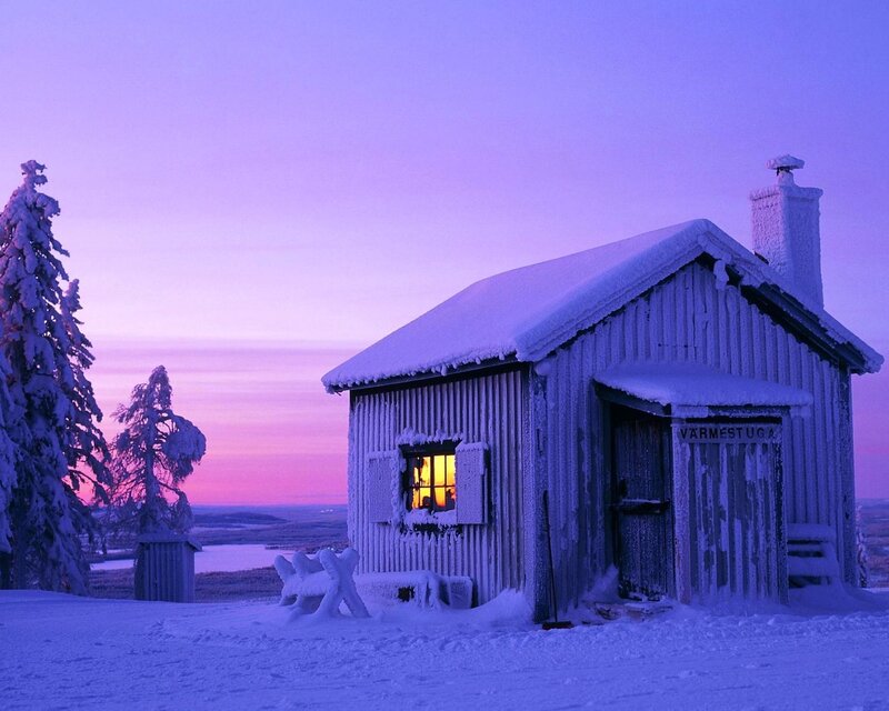Snowy cabin at dusk