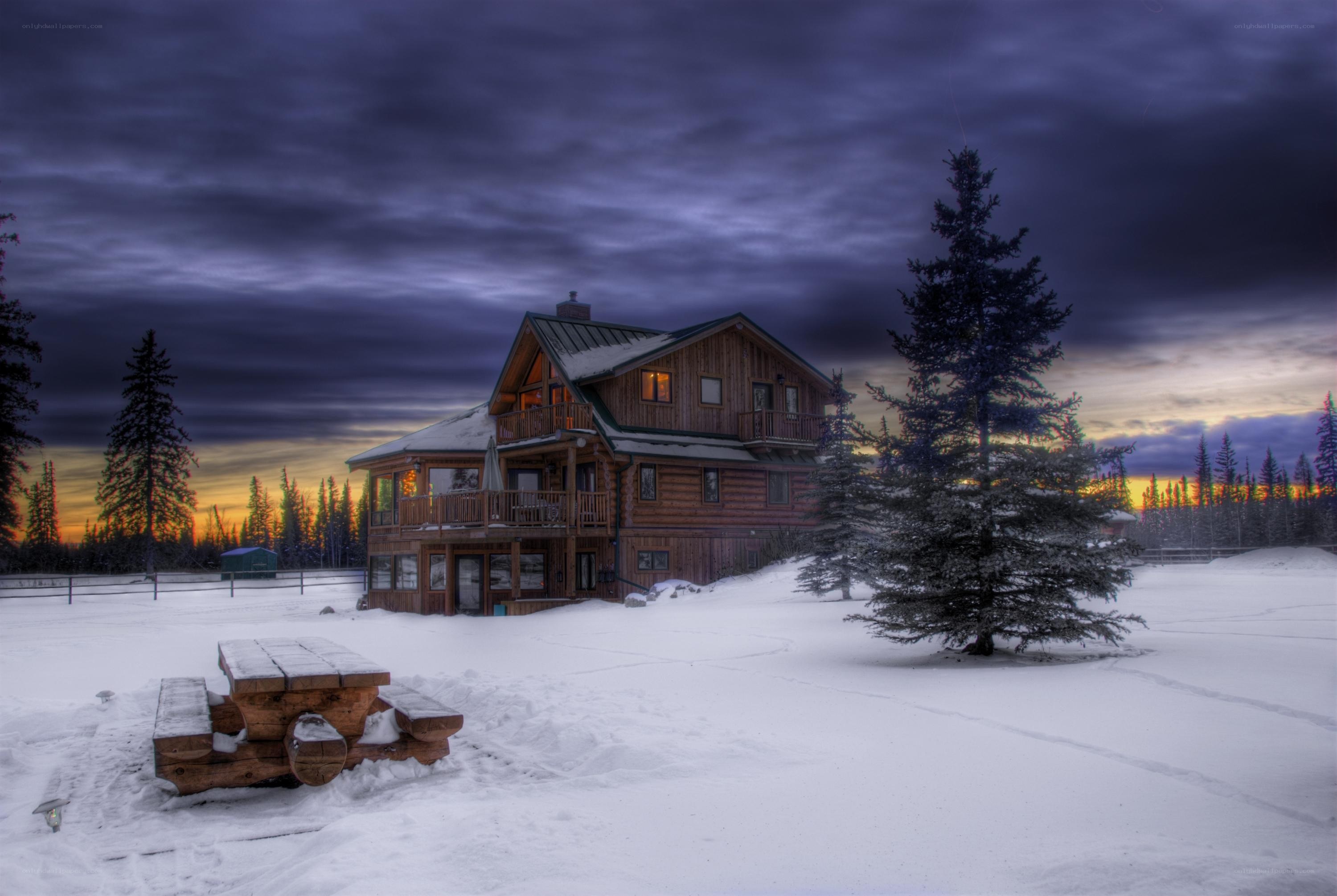 Snowy cabin at dusk