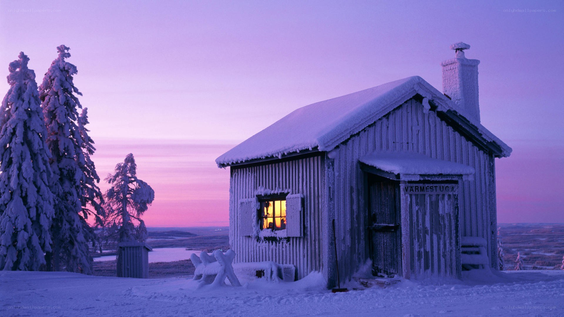 Snowy cabin at dusk