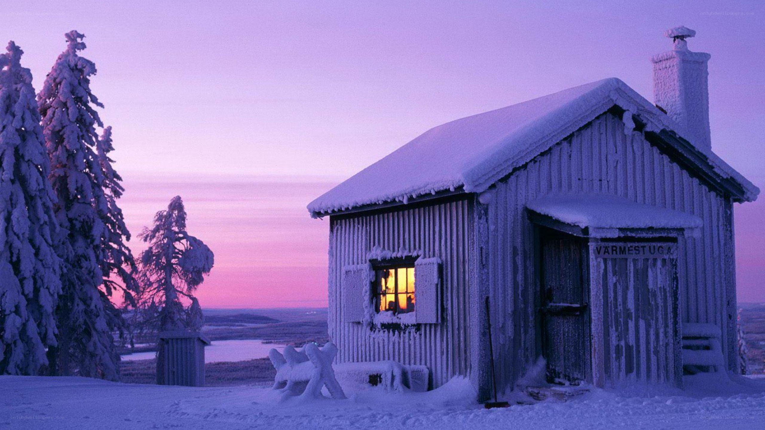 Snowy cabin at dusk