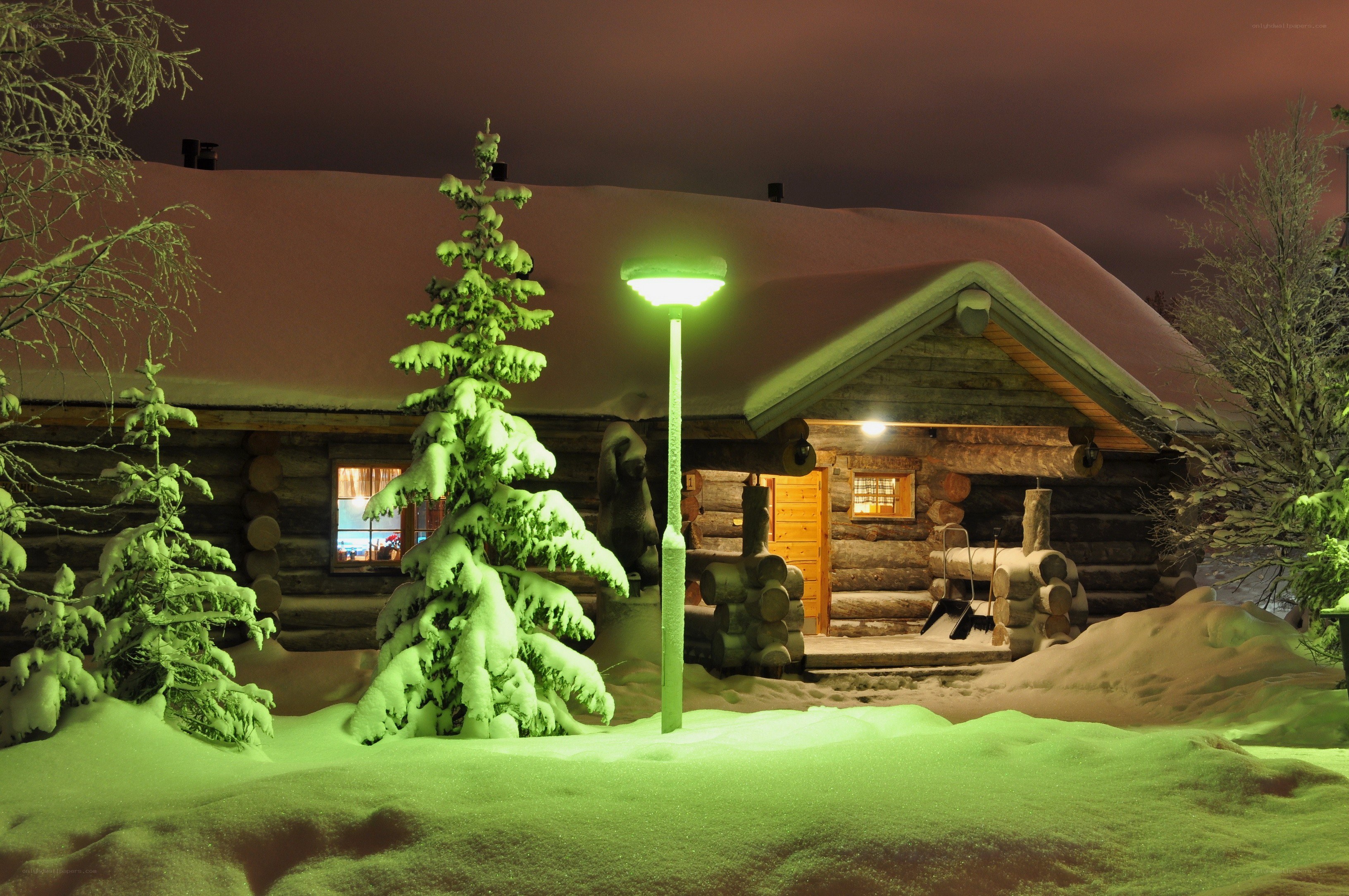 Snowy cabin at night