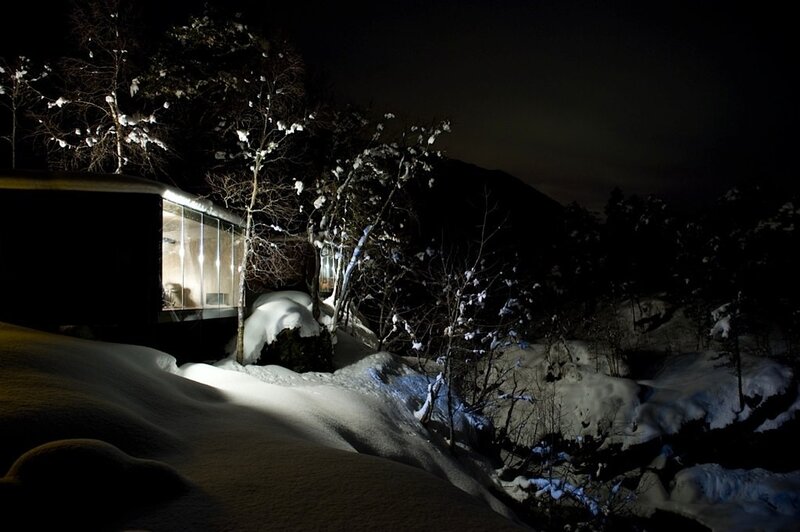 Snowy cabin at night