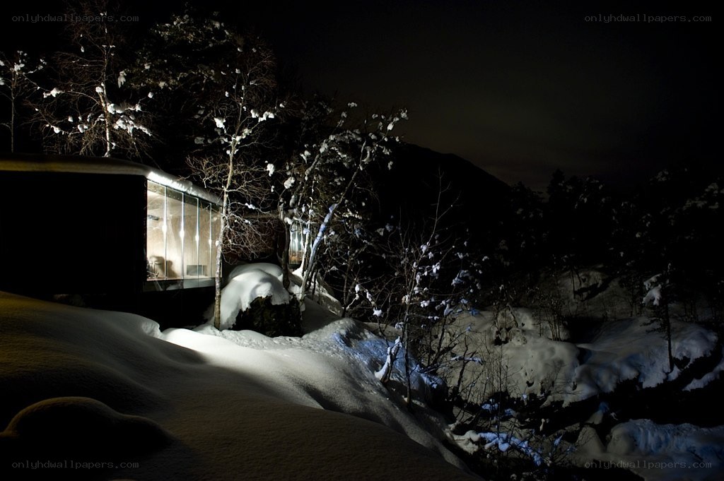 Snowy cabin at night