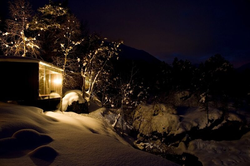 Snowy cabin at night