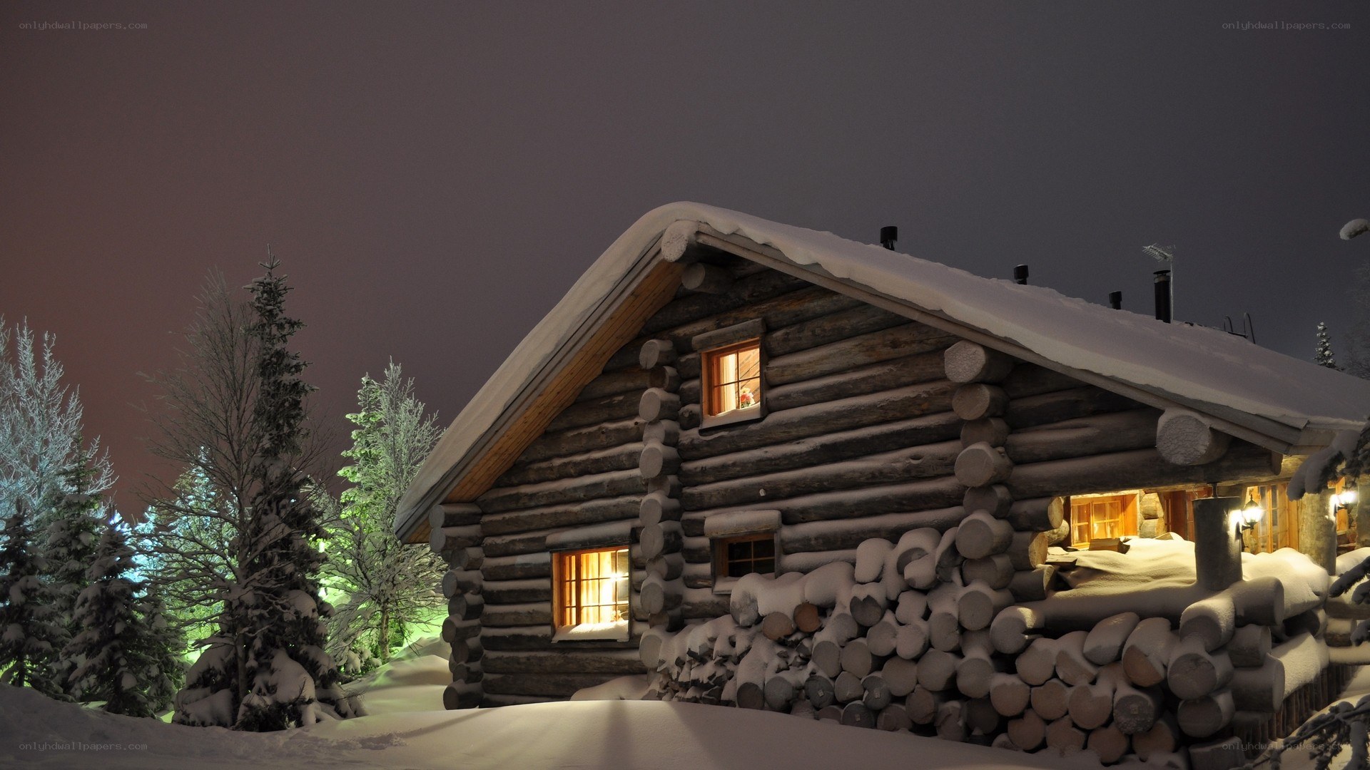 Snowy cabin at night