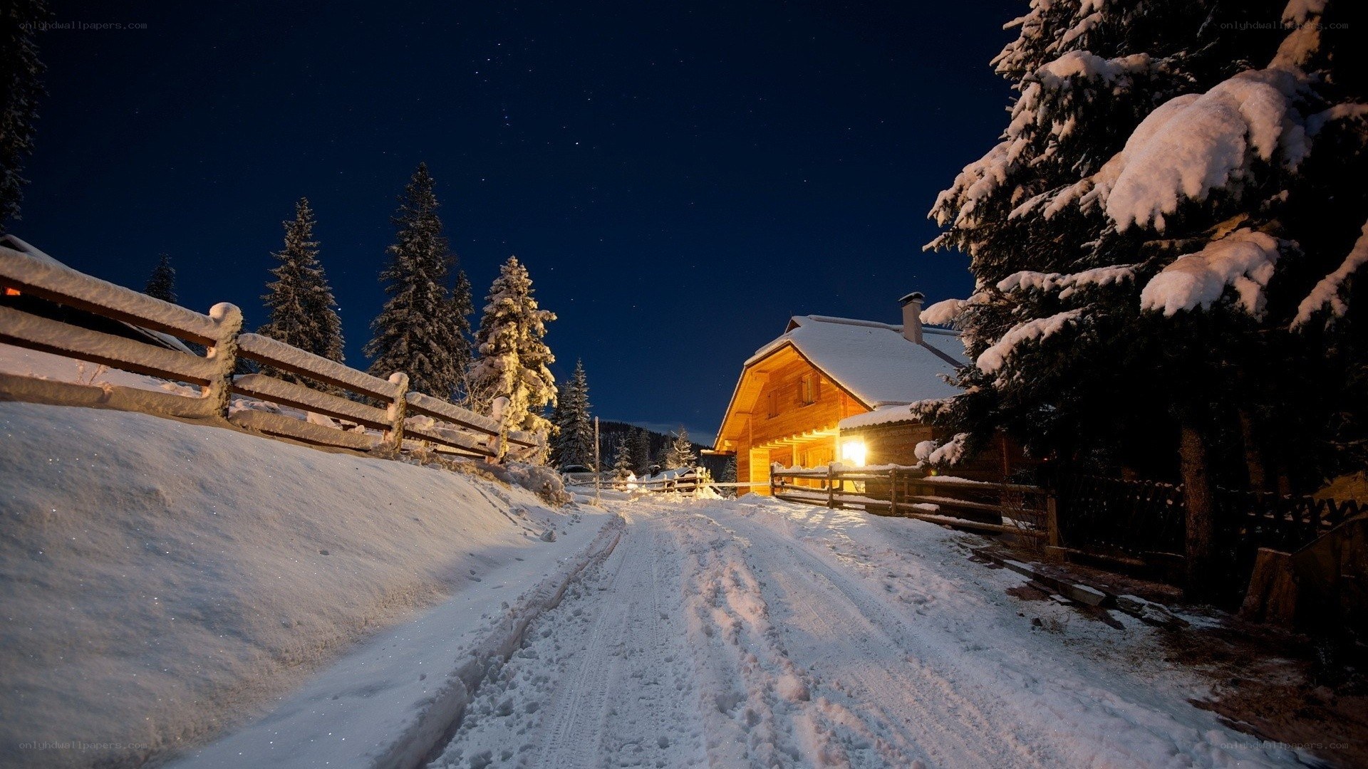 Snowy cabin at night