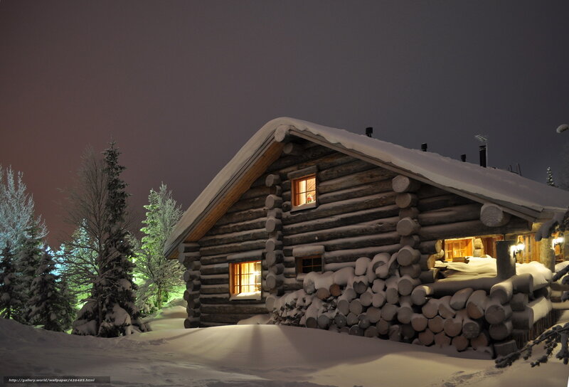 Snowy cabin at night