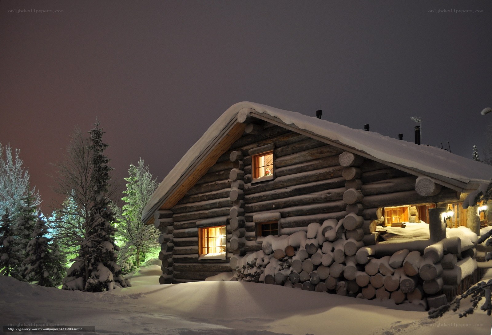 Snowy cabin at night