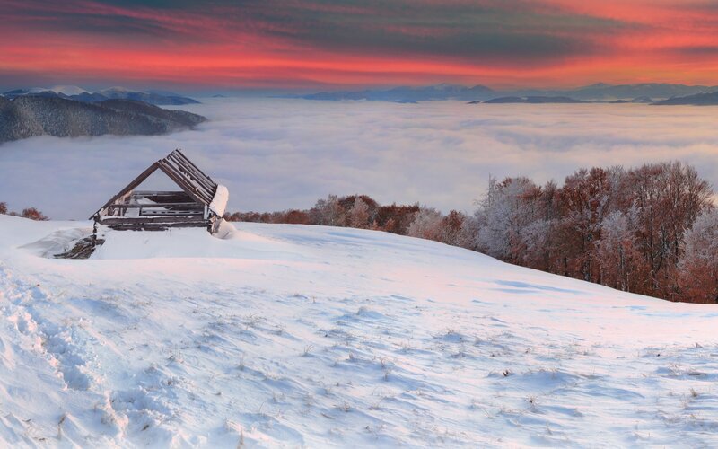 Snowy cabin at sunrise