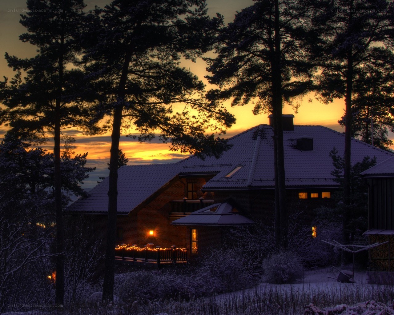 Snowy cabin at sunset