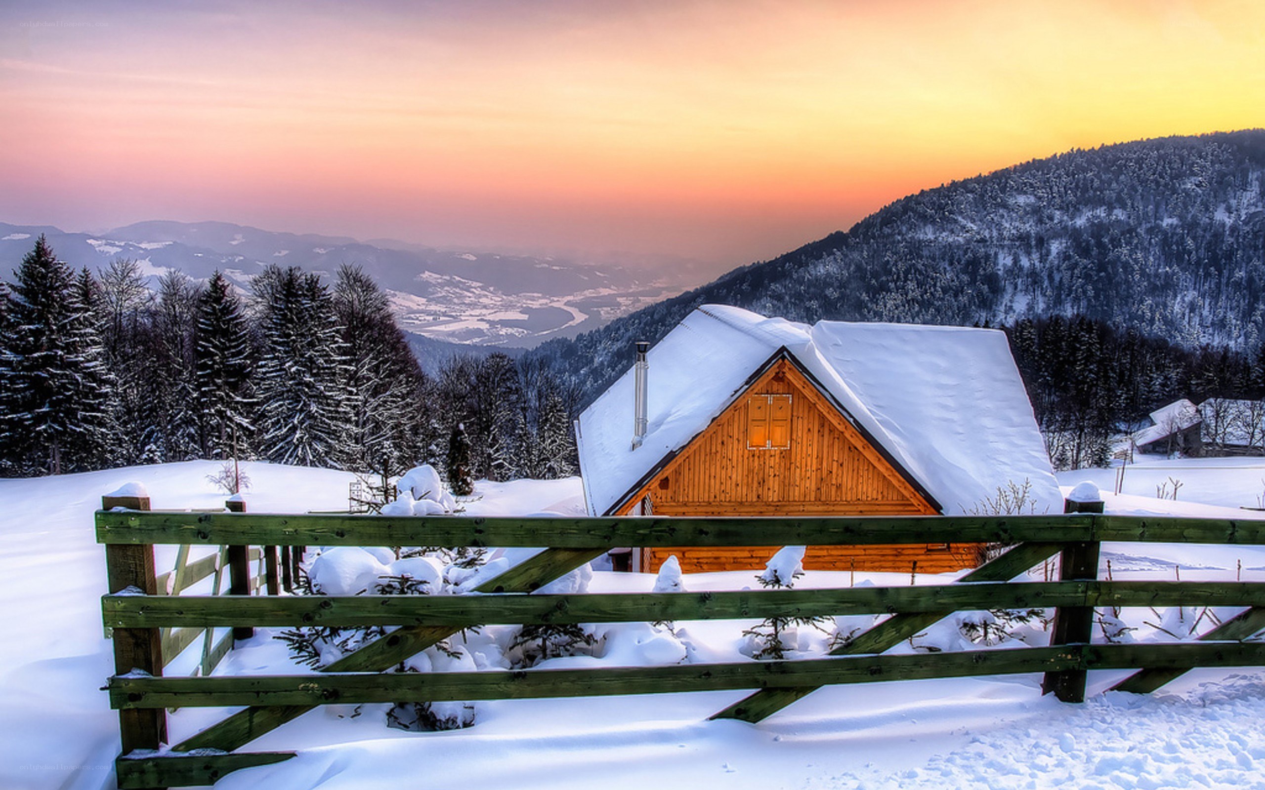 Snowy cabin at sunset