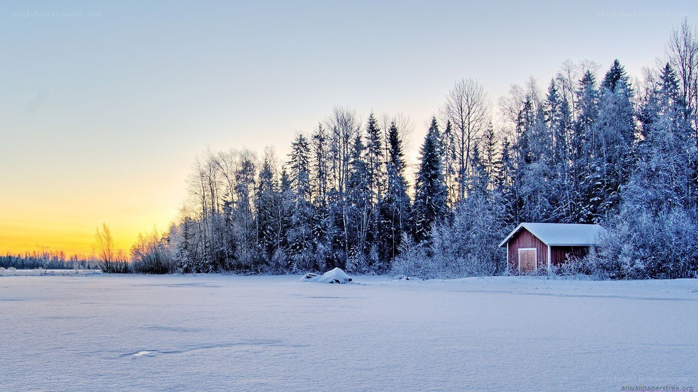 Snowy cabin at sunset