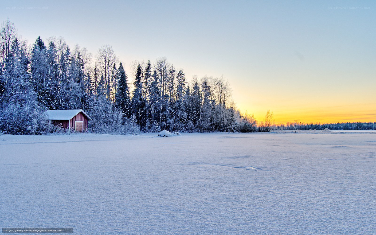 Snowy cabin at sunset