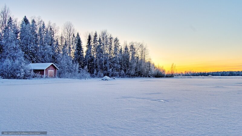 Snowy cabin at sunset