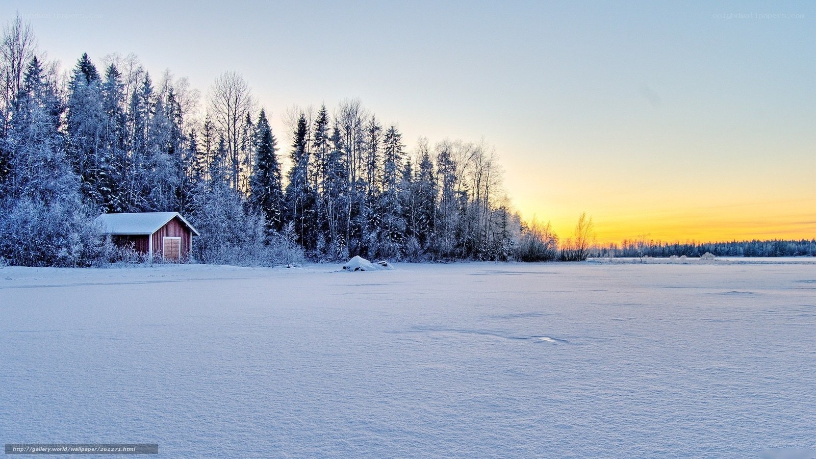 Snowy cabin at sunset