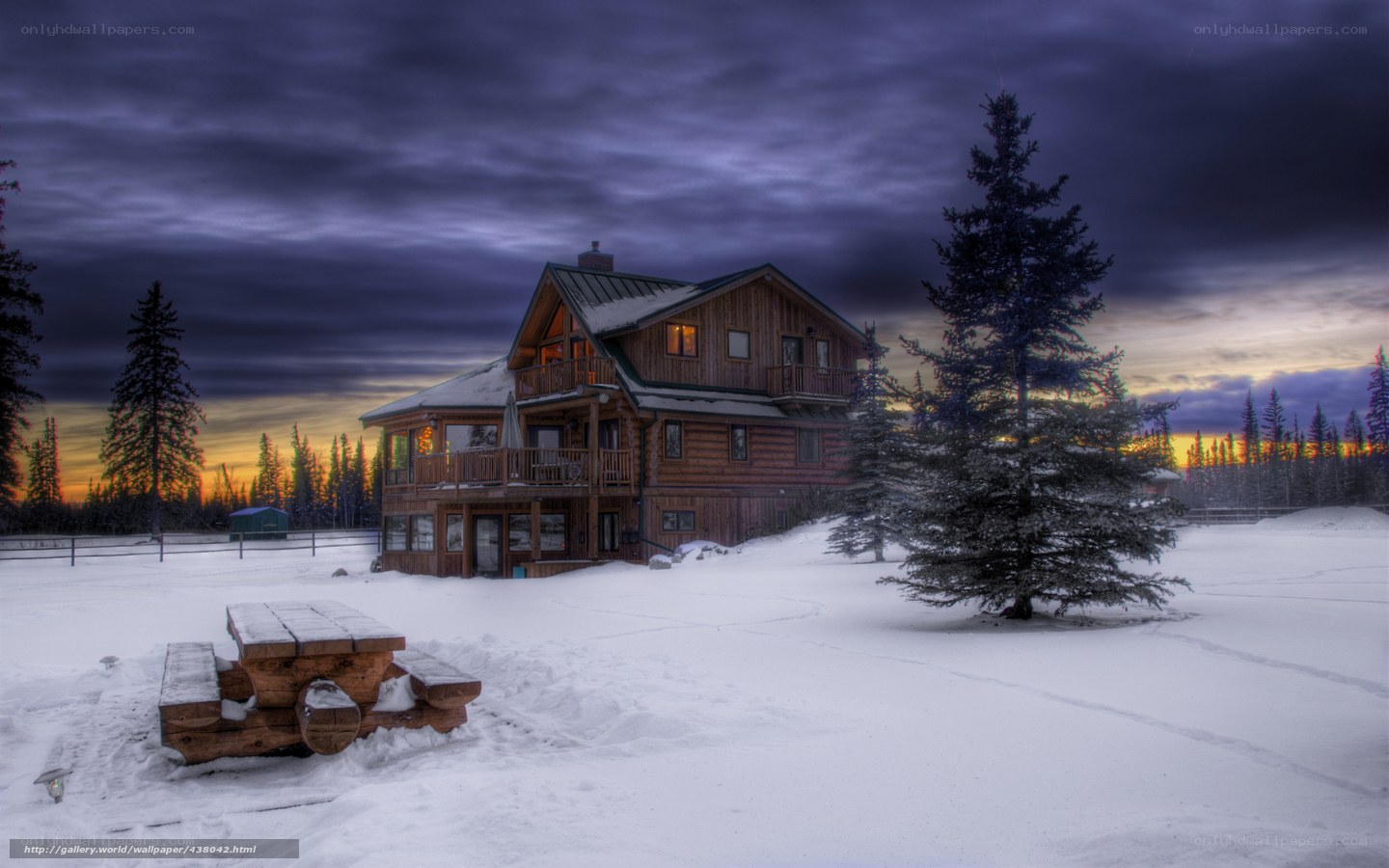 Snowy cabin at sunset