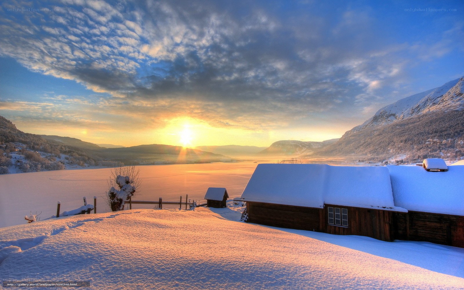 Snowy cabin at sunset