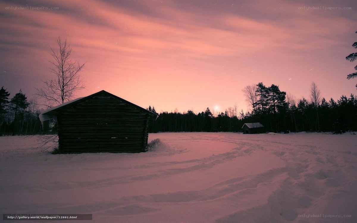 Snowy cabin at sunset