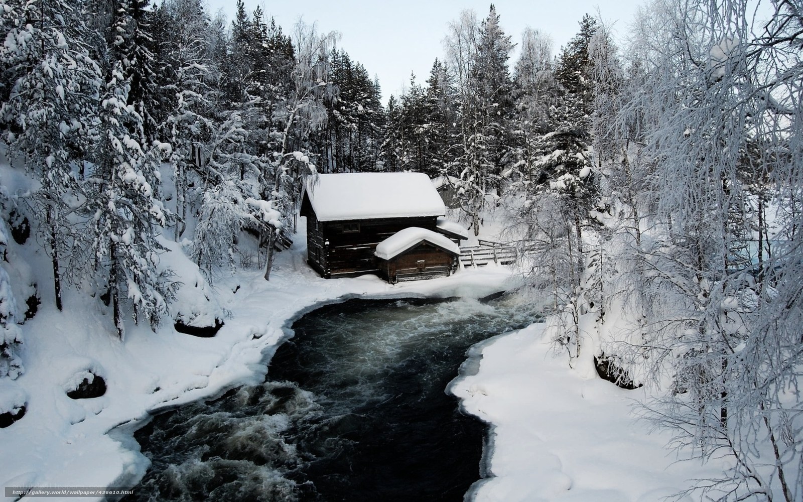 Snowy cabin by a river