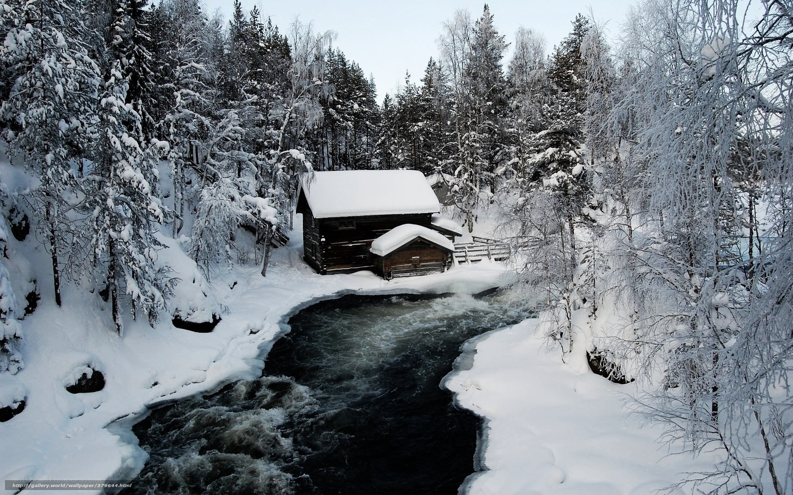 Snowy cabin by a river