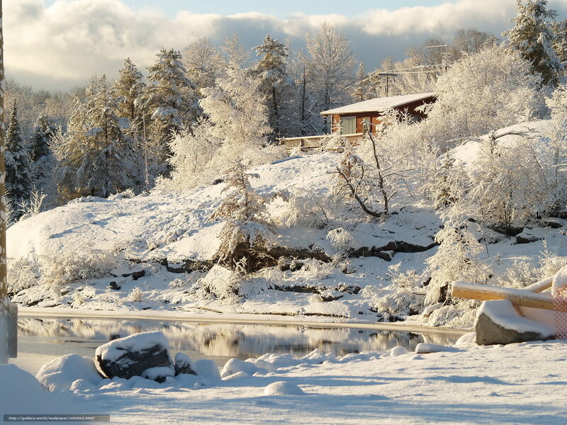 Snowy cabin by the lake