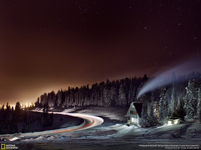 Snowy cabin under starry sky