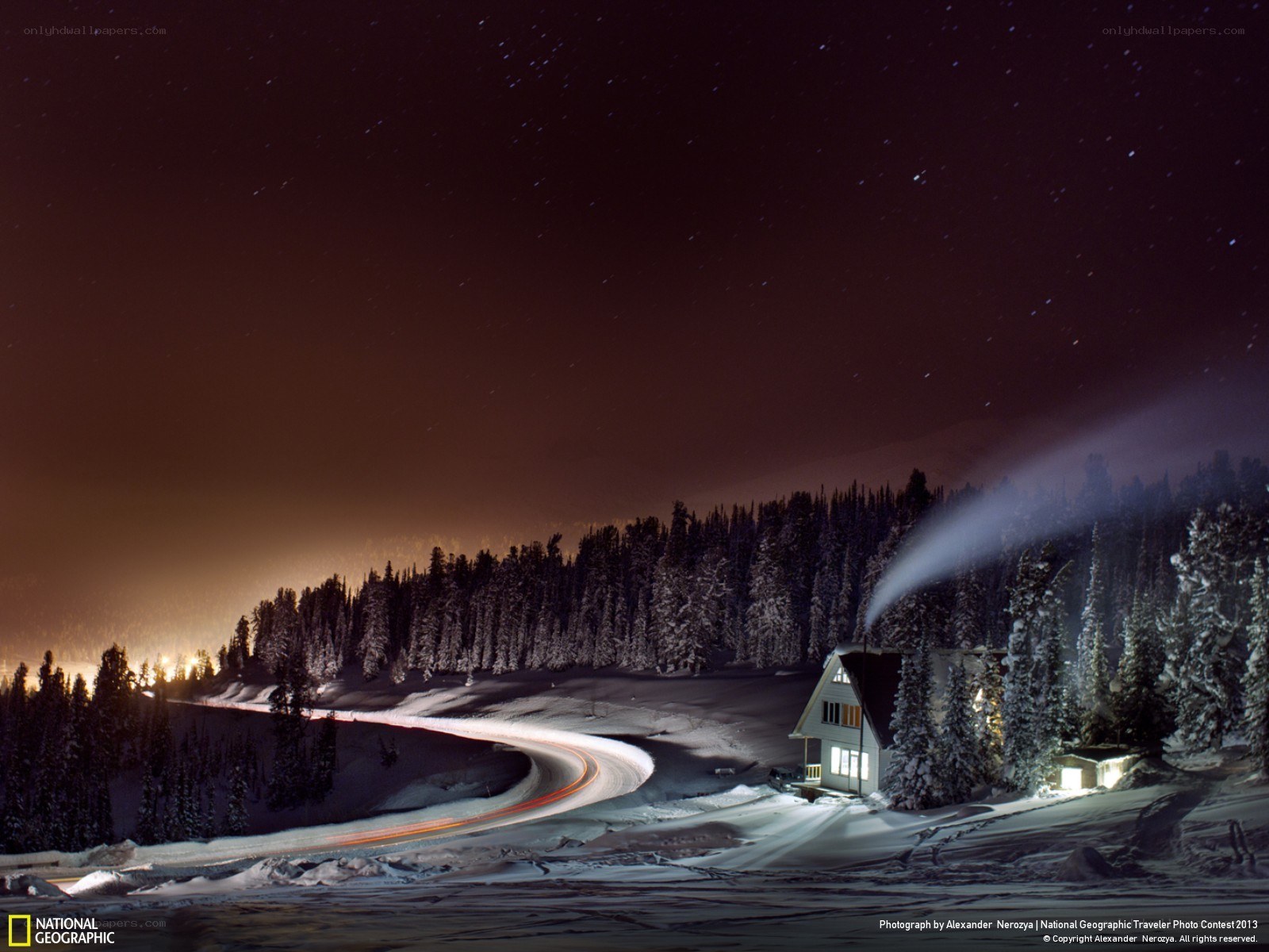 Snowy cabin under starry sky