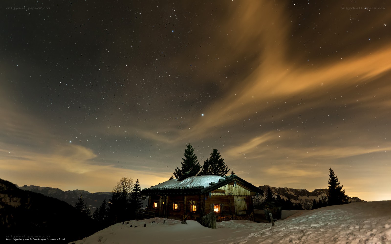 Snowy cabin under starry sky