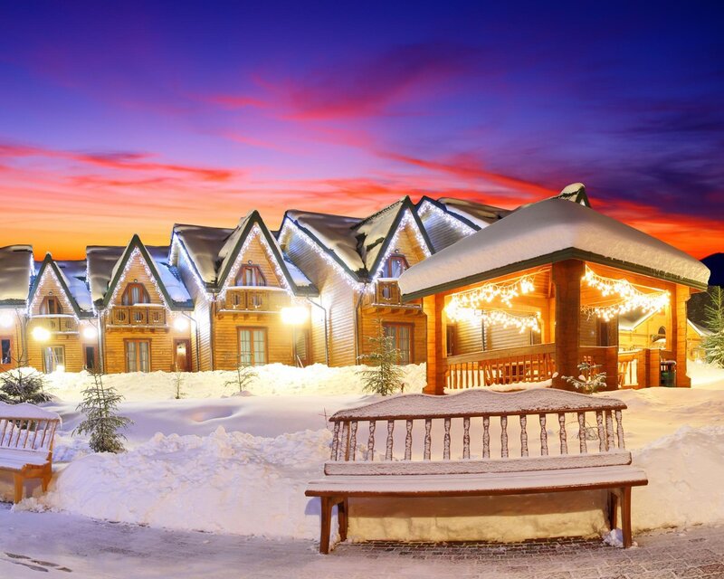 Snowy cabin village at dusk
