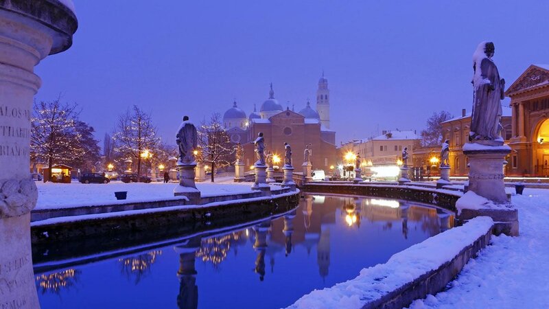 Snowy canal at dusk in Verona