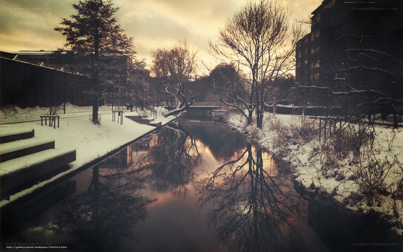 Snowy canal at sunset