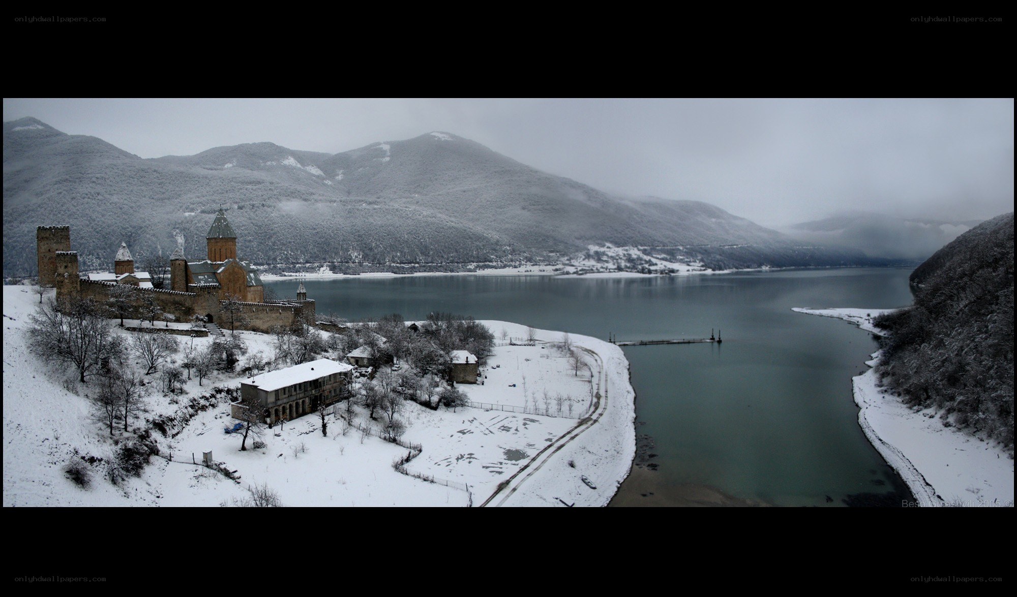 Snowy castle by a lake