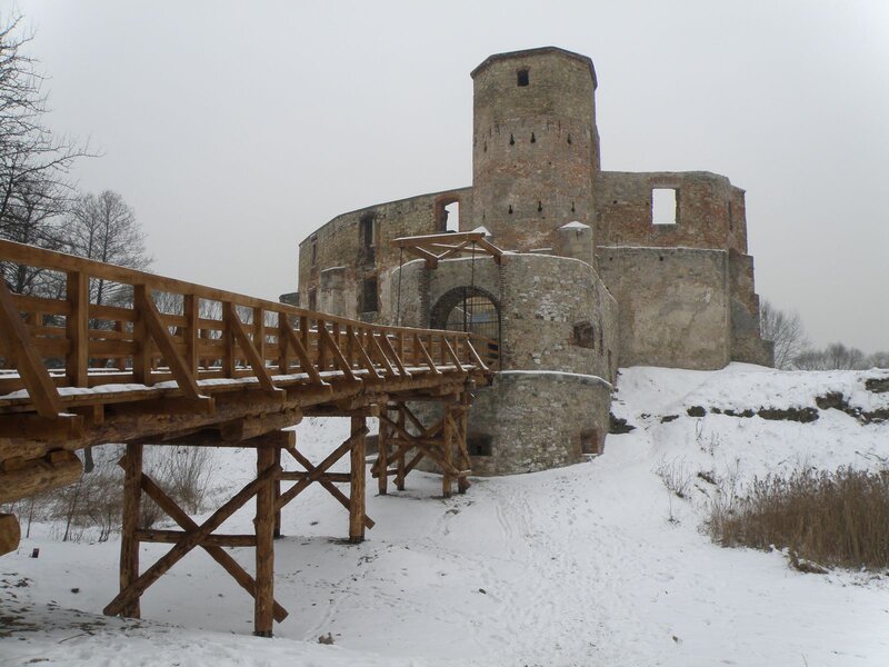 Snowy castle ruins with wooden bridge